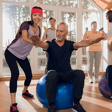 A diverse group of individuals engaging in a workout routine on exercise balls.